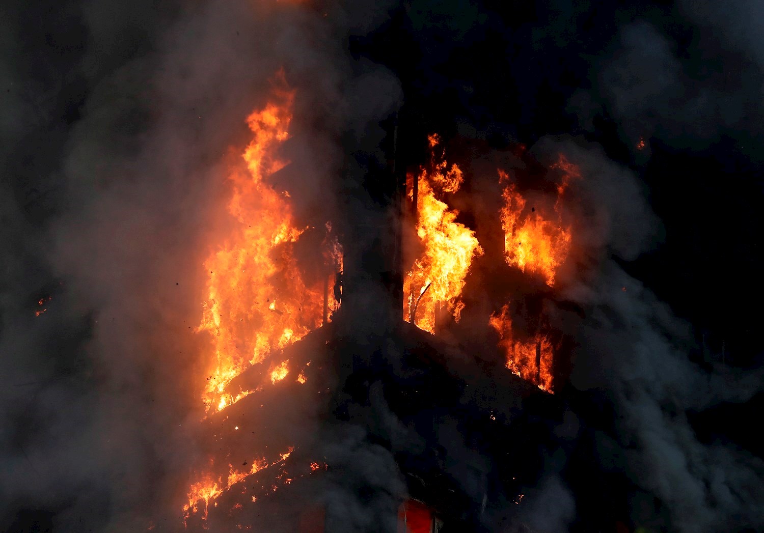 Smoke and flames rise from the building. Photo / AP