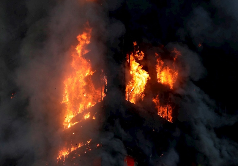 Smoke and flames rise from the building. Photo / AP