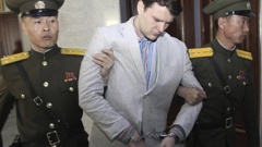 American student Otto Warmbier, center, is escorted at the Supreme Court in Pyongyang, North Korea. Photo / AP