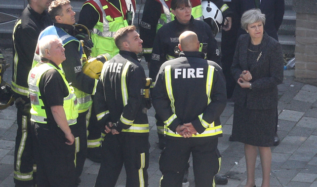 Prime Minister Theresa May speaks to members of the fire service at Grenfell Tower (Getty Images) 