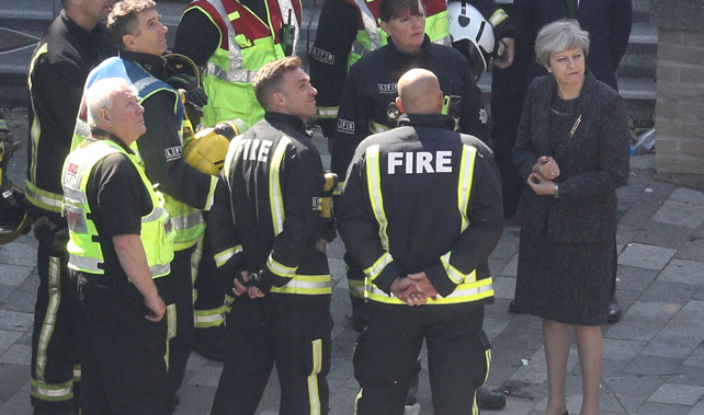 Prime Minister Theresa May speaks to members of the fire service at Grenfell Tower (Getty Images)