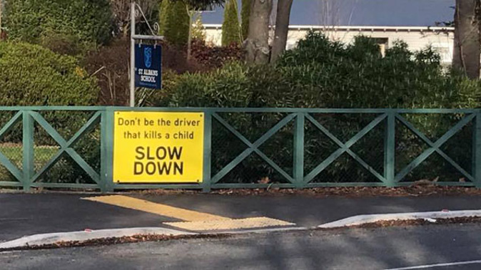 Rachel Donaldson put up five signs near St Albans School, urging drivers to follow the road rules (Josh Price)