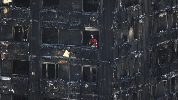 Urban Search and Rescue officers from London Fire Brigade inside the Grenfell Tower in west London after fire engulfed the 24-storey building. (Photo / AP)