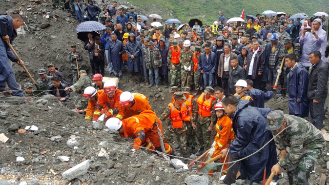 The landslide swept over more than 60 homes as dawn broke on Saturday in Xinmo, a remote village in north Sichuan province. (Getty)