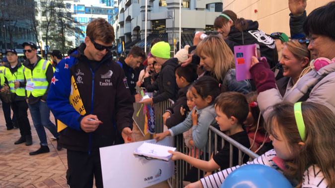 Fans have lined up for hours in Wellington to get a glimpse of the America's Cup as it passed through the city. (Georgia Nelson)