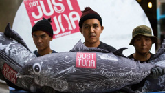 Greenpeace activists place a large mock-up of a SEALECT canned tuna in front of the Thai Union Headquarters, in Bangkok, to challenge the company to change their practices. (Photo / Supplied)