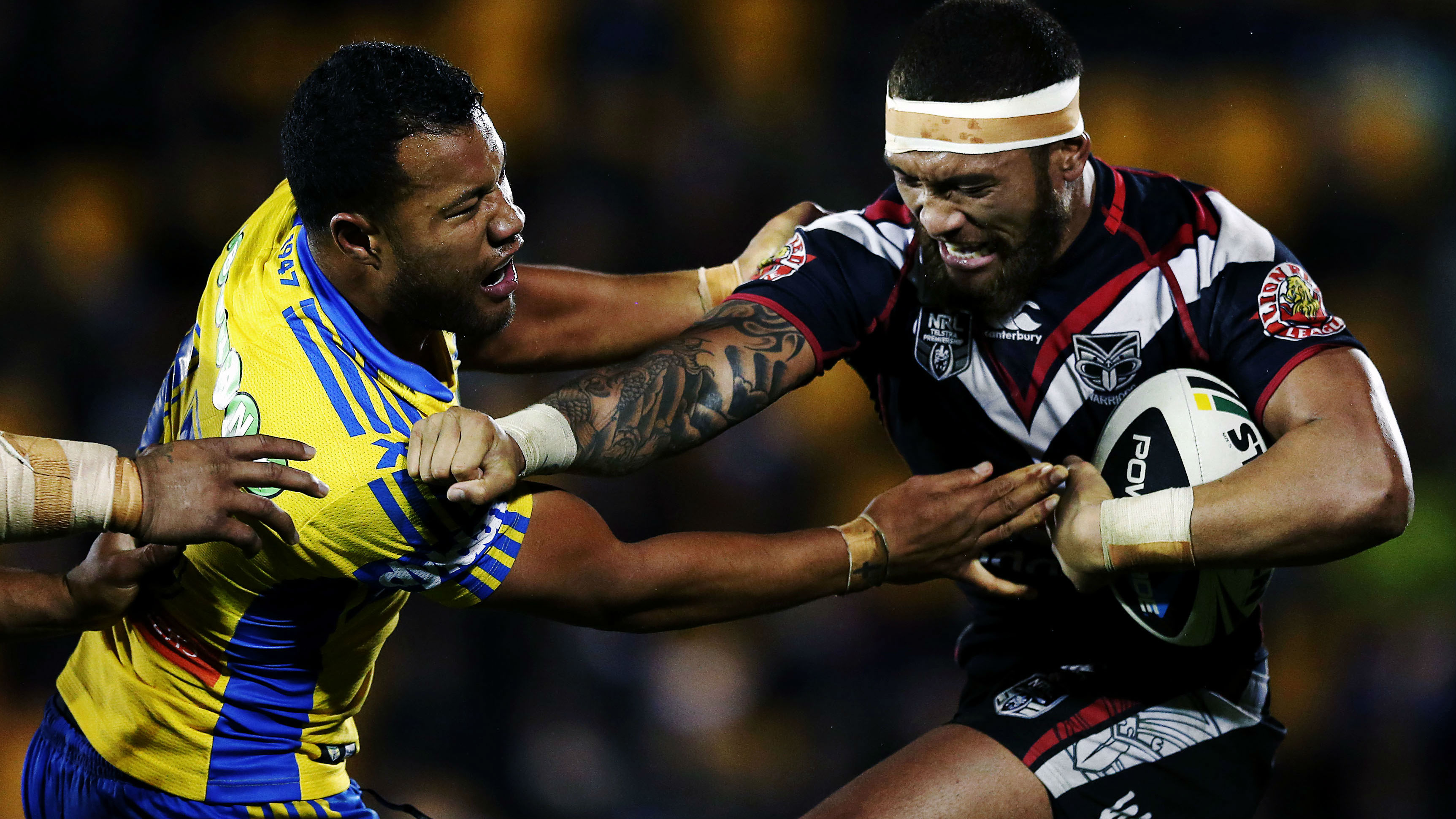 Manu Vatuvei of the Warriors fends off Joseph Paulo of the Eels. Round 18 NRL Telstra Premiership game, Vodafone Warriors v Parramatta Eels, Mt Smart Stadium, Auckland, New Zealand. Photosport.