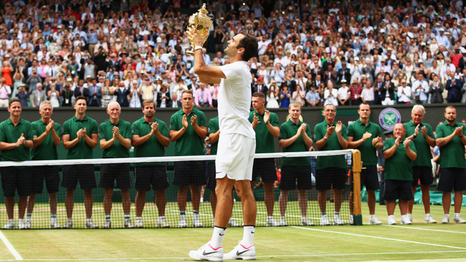 Roger Federer of Switzerland celebrates victory with the trophy after the Gentlemen's Singles final against Marin Cilic of Croatia on day thirteen of the Wimbledon Lawn Tennis Championships at the All England Lawn Tennis and Croquet Club at Wimbledon on July 16, 2017 in London. Getty Images.