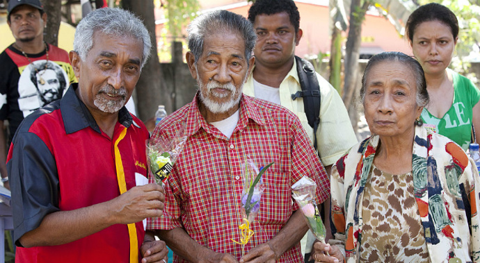 Mr Mari Alkatiri (L) campaigned for Fretalin by handing out flowers to voters as a sign of goodwill and peace, ahead of the election. (Getty)