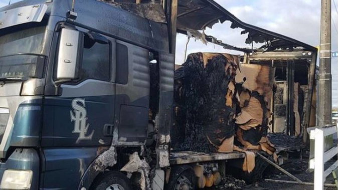 A car burst into flames when it crashed into the back of a large truck parked on the side of the road. (Supplied) 