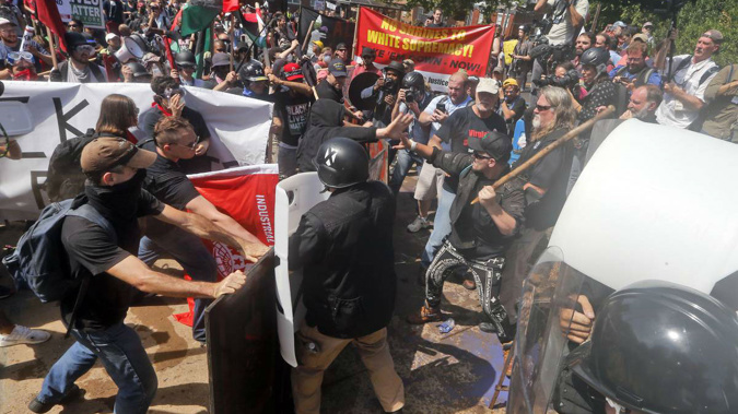White nationalist demonstrators clash with counter demonstrators at the entrance to Lee Park in Charlottesville. Photo / AP