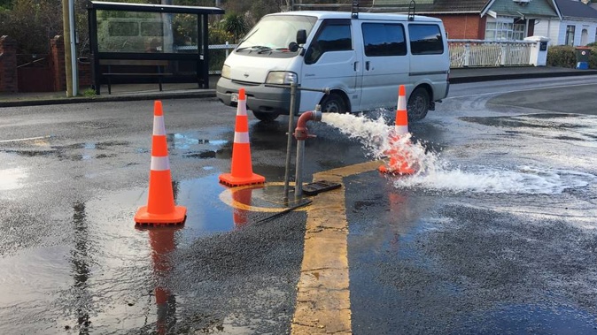 Dunedin City Council contractors flush water out of a water main on Malvern St in an effort to clear the contamination. (Photo / Craig Baxter, Otago Daily Times)