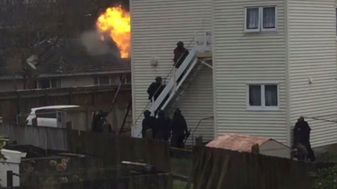 Armed Offenders Squad members storm the property (NZH)