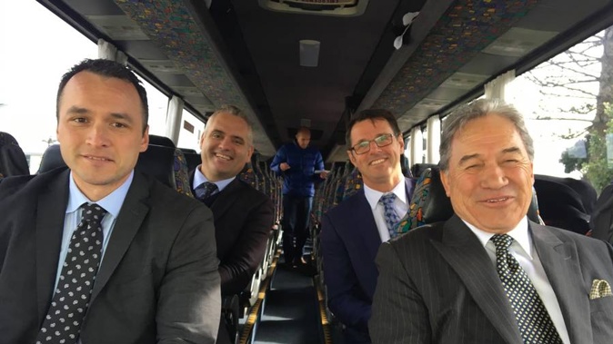 New Zealand First leader Winston Peters aboard his campaign bus with MPs Darroch Ball (left), Fletcher Tabuteau (rear left) and Clayton Mitchell (rear right). (Photo / Claire Trevett)