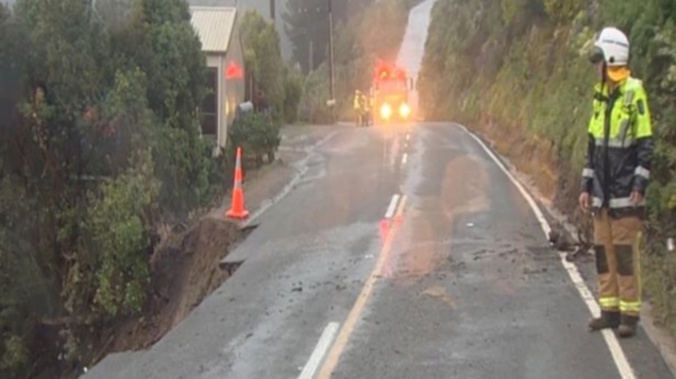 Police closed Marine Dr in Lyttelton Harbour after they were notified of the slip there about 6am. (Photo: Broadcast Media)