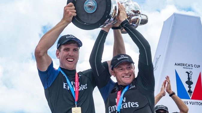Team New Zealand Helmsman Peter Burling and skipper Glenn Ashby hold aloft the America's Cup. (Photo \ Photosport)