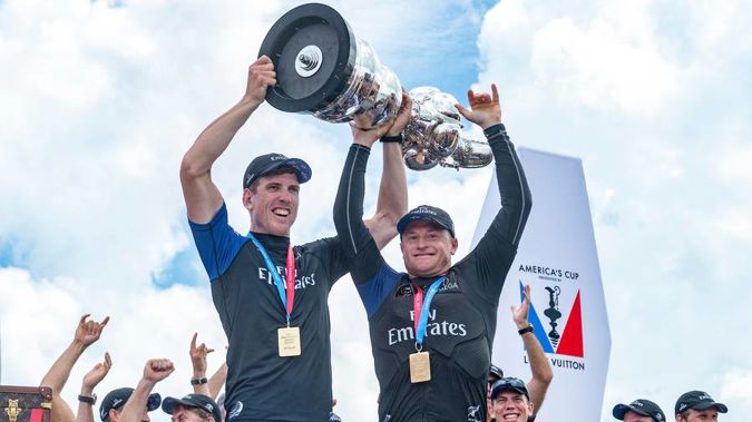 Team New Zealand helmsman Peter Burling and skipper Glenn Ashby hold aloft the America's Cup. (Photo \ Photosport)