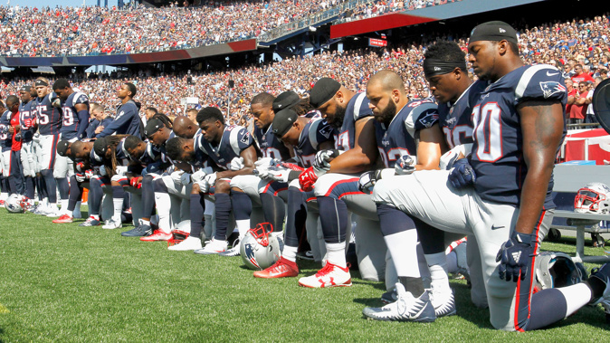 Members of the New England Patriots kneel during the National Anthem (Getty)