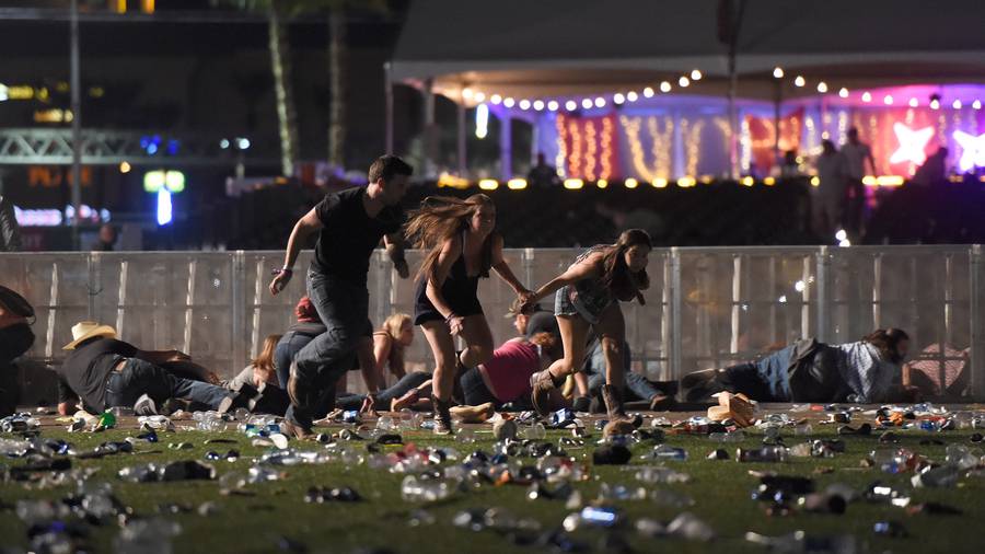 People run from the Route 91 Harvest country music festival after gun fire was heard yesterday. (Photo / AP)