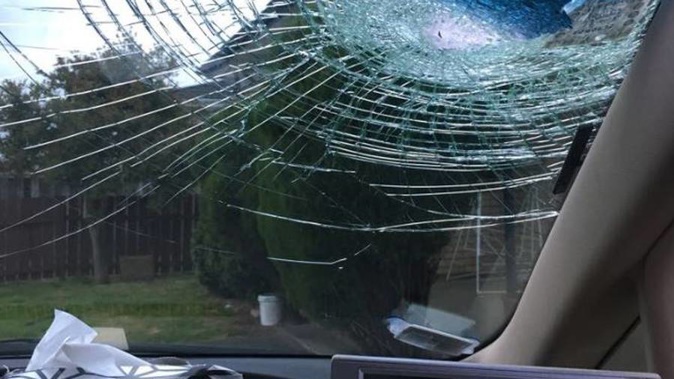 A rock hurled from an Auckland motorway overbridge has smashed into the windscreen of a taxi. (Photo / Supplied)