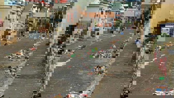 Glass and rubbish remained strewn over Hyde St in Dunedin. (Photo / Hamish McNeilly)