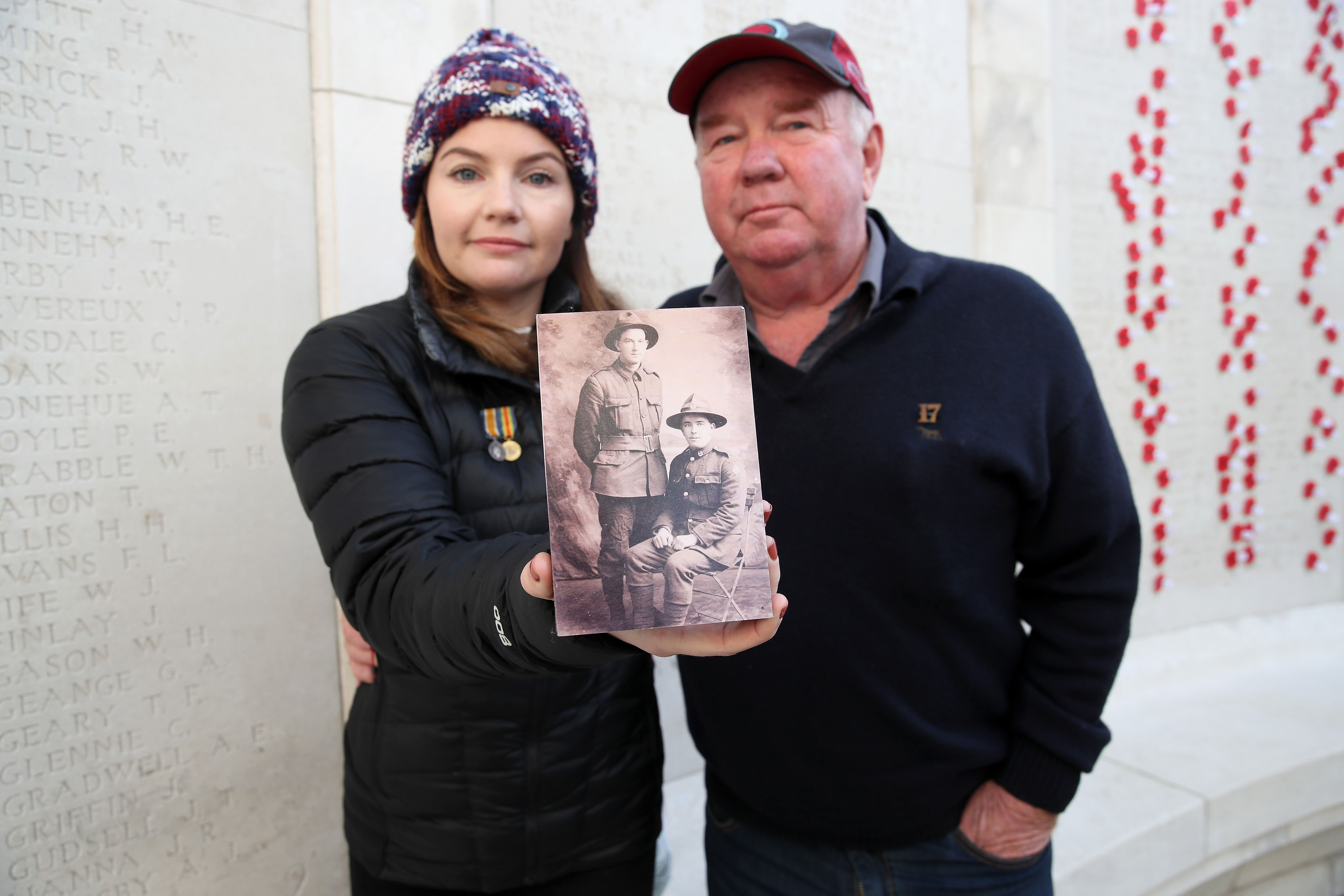 Kate Thomas and her father Jim Kiesanowski with a photograph of her grandfather Morris Crimmins and her great uncle John Patrick (sitting) killed in action
