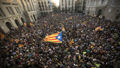 People wave 'estelada' or pro-independence flags outside Palau Generalitat in Barcelona after Catalonia's regional parliament passed a motion establishing an independent Catalan Republic. (Photo / AP)