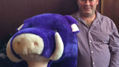 Bruce Smith poses with a pig soft toy. Photo/Facebook