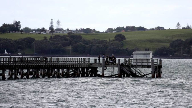 Emergency services at Torpedo Bay wharf in Devonport after reports of a child falling into the water. Photo / NZ Herald