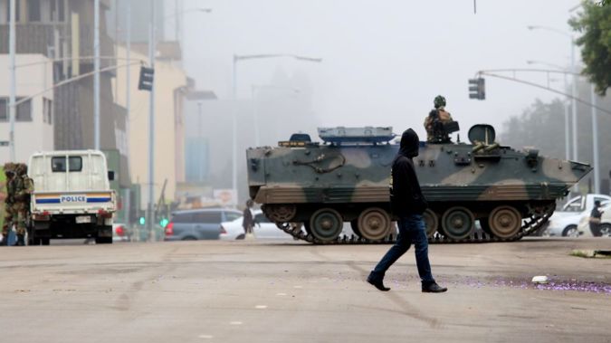 A military tank seals off a main road to the presidential office within the military activities taking place in Harare, Zimbabwe on November 15, 2017. (Photo by Stringer/Anadolu Agency/Getty Images)