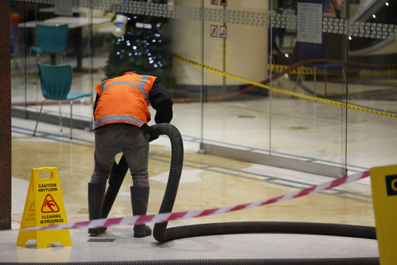 Contractors clean up food oil spill at Elliott food court in Auckland.