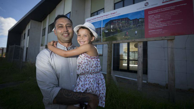Spokesperson Ngarimu Blair with his daughter outside housing development on Ngati Whatua land in Orakei. (Photo/Dean Purcell)