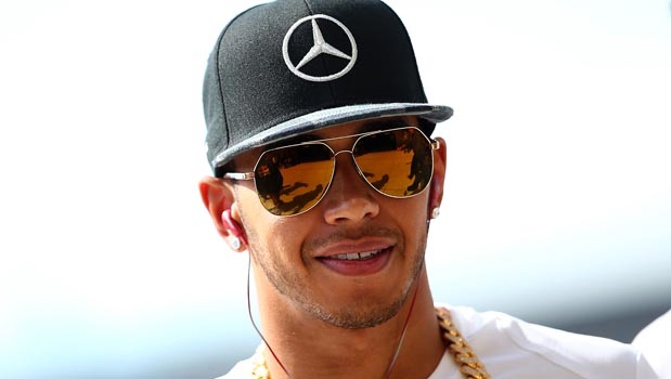 Lewis Hamilton has apologised for posting a video where he tells his young nephew that 'boys don't wear dresses'.