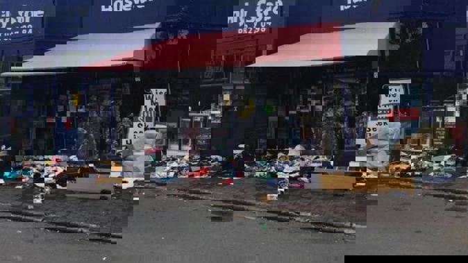 Piles of rubbish strewn about outside the New Lynn Salvation Army family store on Boxing Day. (Photo / Facebook)