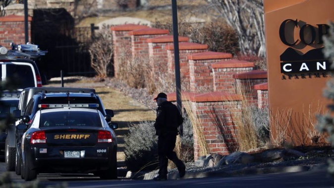 An investigator heads to the scene of a shooting in Highlands Ranch, Colorado. (Photo / AP)