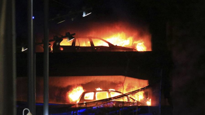 Vehicles burn during a blaze at a multi-storey car park at the Echo Arena on the waterfront in Liverpool. (Photo / AP)