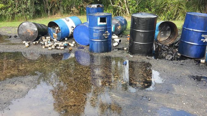 Around 10 drums were found, some with oil spilling out, after they were dumped on Piha Rd. (Photo / Sarah Munro)