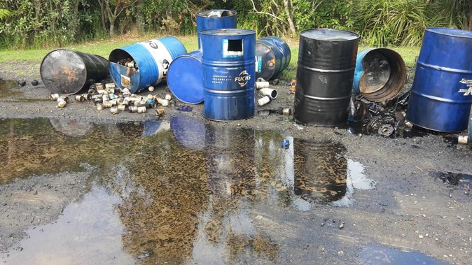 Around 10 drums were found, some with oil spilling out, after they were dumped on Piha Rd. (Photo / Sarah Munro)