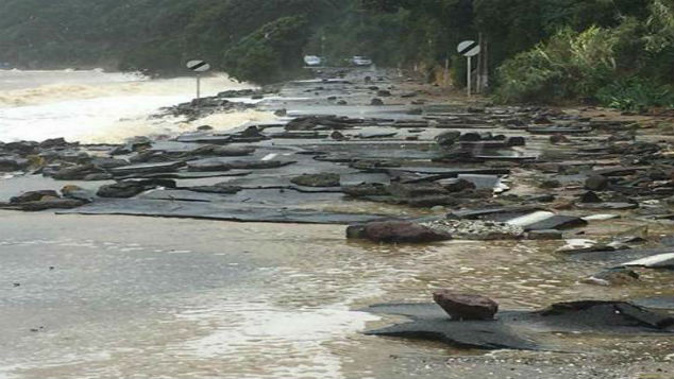 The Thames Coast Rd was severely damaged in last week's storm to hit New Zealand. (Photo \ Thames District Fire Brigade)