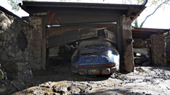 A car sits parked in the garage of a home that was damaged by a mudslide. (Photo / Getty Images)