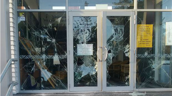 The attacker used a hammer to smash every pane in the college's strengthened glass entrance. (Photo / Supplied)