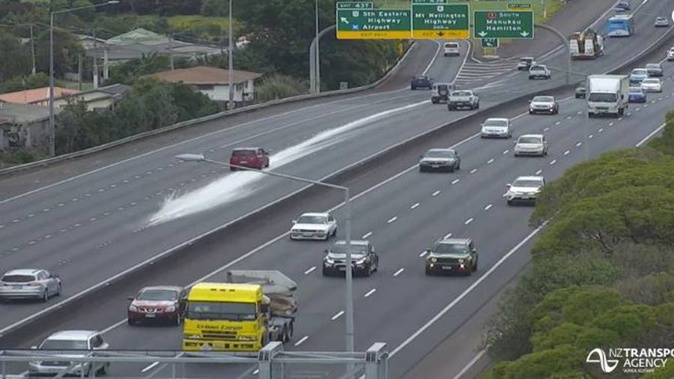 A large amount of white paint is covering a section of Auckland's Southern Motorway. (Photo / Twitter)