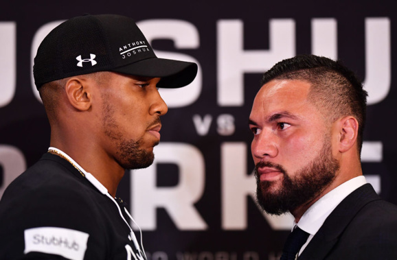 Anthony Joshua and Joseph Parker face off at their press conference in London this morning, NZ time. (Photo \ Getty Images)