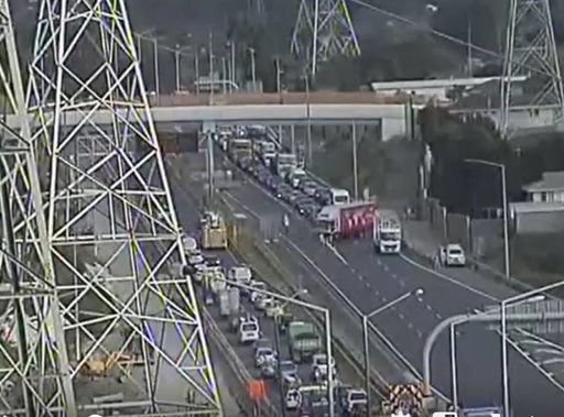 A crashed truck is blocking both lanes of the Northwestern Motorway closing the motorway and leaving scores of cars with no where to go. (Photo / NZTA)