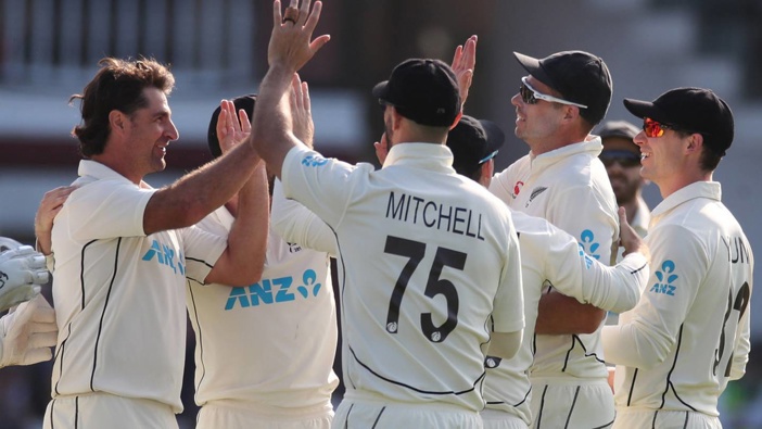Colin de Grandhomme celebrates dismissing Joe Root with his teammates. Photo / Photosport