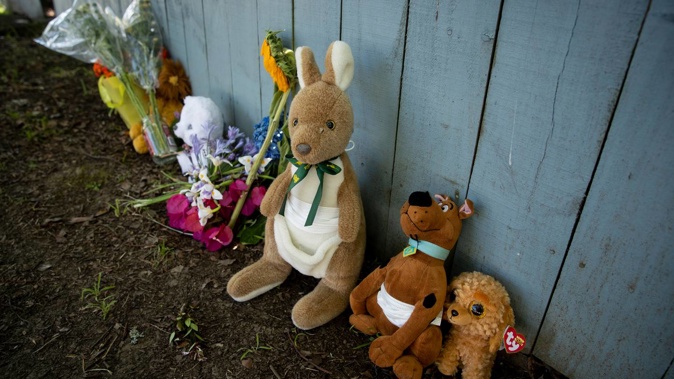 Flowers and toys have been left outside a property on Vandeleur Ave in Birkdale while a homicide investigation continues. Photo / Dean Purcell