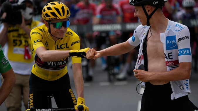 Denmark's Jonas Vingegaard, wearing the overall leader's yellow jersey, and Slovenia's Tadej Pogacar, wearing the best young rider's white jersey, pump fists. (Photo / AP)