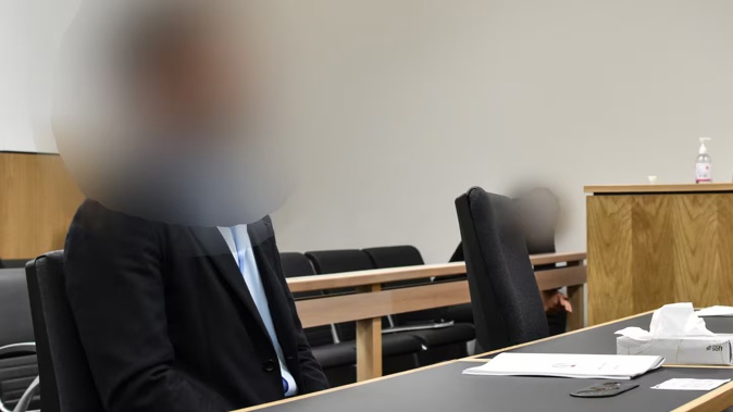 An Auckland businessman accused of assaulting a woman in March 2022 sits in court on the first day of his trial in the Auckland District Court on November 26, 2024. Photo / George Block