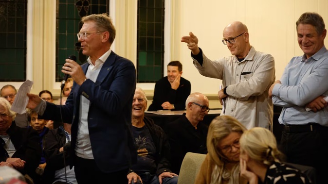 Ōrākei Local Board member Troy Churton gestures towards Minister Paul Goldsmith at last week's public meeting in Mt Eden. Photo / Sylvie Whinray