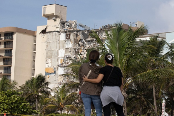 Maria Fernanda Martinez and Mariana Cordeiro look on as search and rescue operations continue at the site of the partially collapsed 12-story condo building on Friday in Surfsid. Photo / Getty Images
